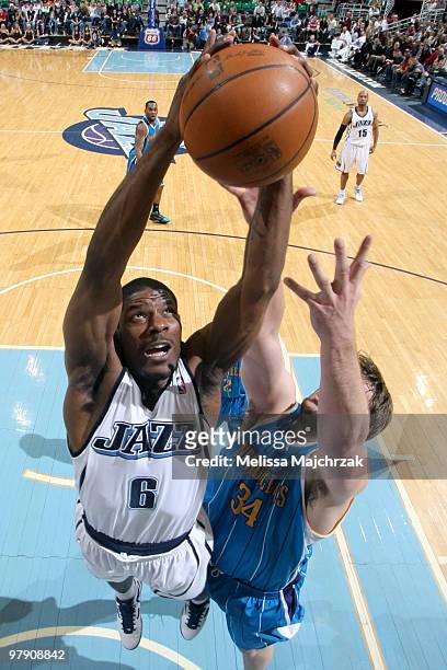 Othyus Jeffers of the Utah Jazz goes for the layup over Aaron Gray of the New Orleans Hornets at EnergySolutions Arena on March 20, 2010 in Salt Lake...