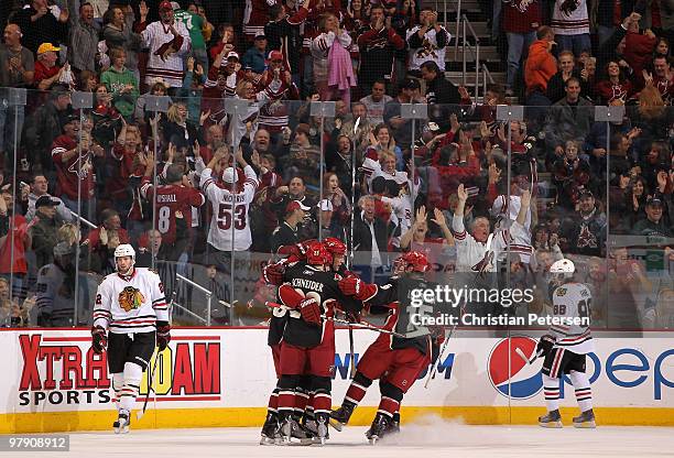 Adrian Aucoin of the Phoenix Coyotes is surrounded by teammates Taylor Pyatt, Mathieu Schneider, Matthew Lombardi and Shane Doan after Aucoin scored...