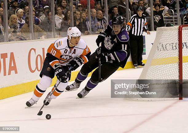 Richard Park of the New York Islanders arries te puck around the net in front of Anze Kopitar of the Los Angeles Kings on March 20, 2010 at Staples...