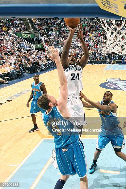 Paul Millsap of the Utah Jazz puts up the shot over Darius Songaila of the New Orleans Hornets at EnergySolutions Arena on March 20, 2010 in Salt...