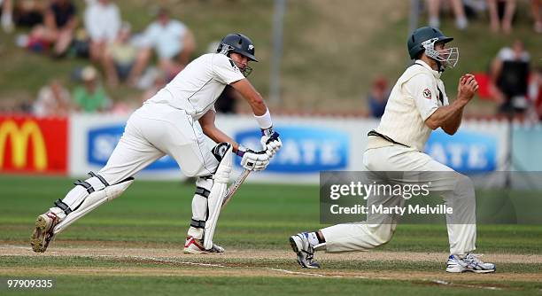 Tim McIntosh of New Zealand gets caught out by Simon Katich of Australia during day three of the First Test match between New Zealand and Australia...