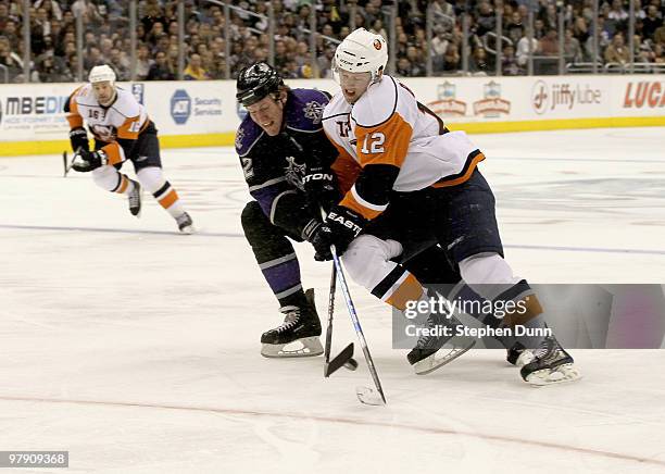 Matt Greene of the Los Angeles Kings pokes the puck away from Josh Bailey of the New York Islanders on March 20, 2010 at Staples Center in Los...