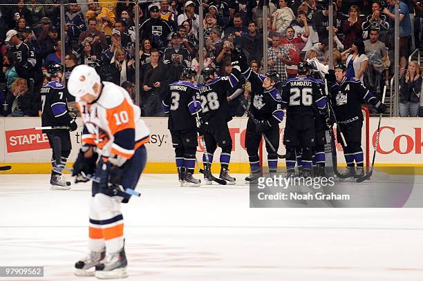 Richard Park of the New York Islanders skates off dejectedly while Jack Johnson, Jarret Stoll, Sean O'Donnell, Michal Handzus, and Matt Greene of the...