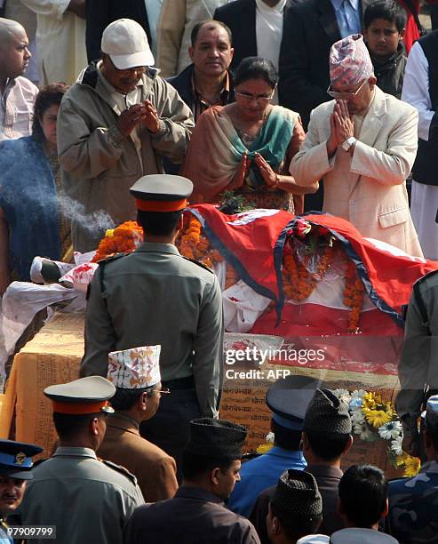 Nepal's Prime Minister Madhav Kumar Nepal and his wife pay their last respect to Nepali Congress president and former prime minister Girija Prasad...