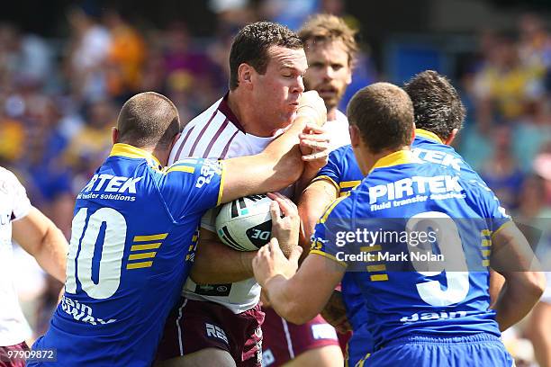 Jason King of the Eagles is tackled during the round two NRL match between the Parramatta Eels and the Manly Sea Eagles at Parramatta Stadium on...