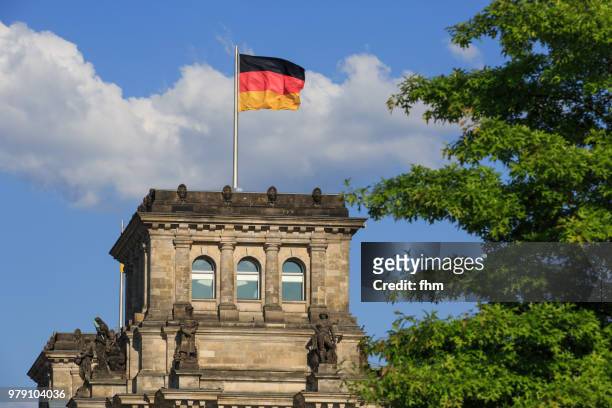 one tower of the reichstag building with german flag (german parliament building) - berlin, germany - architrave stock pictures, royalty-free photos & images