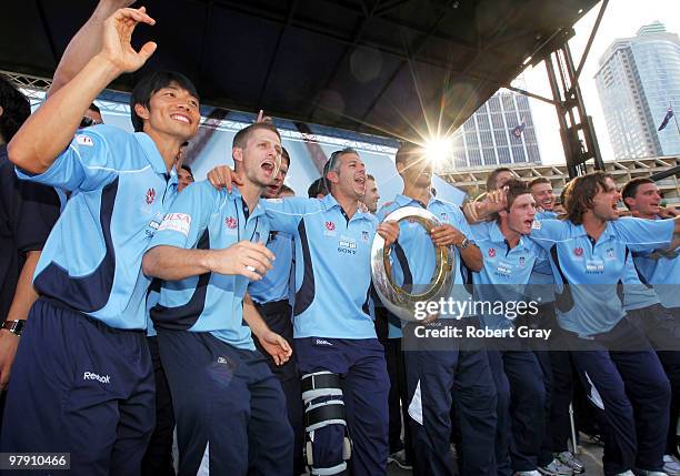 Sydney FC Players hold the trophy and salute the crowd during the Sydney FC A-League Grand Final celebrations at The Domain on March 21, 2010 in...