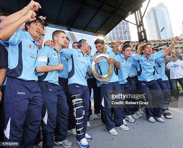 Sydney FC Players hold the trophy and salute the crowd during the Sydney FC A-League Grand Final celebrations at The Domain on March 21, 2010 in...