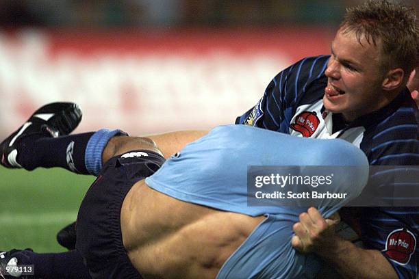 Brendan Williams of the Waratahs has his shirt pulled over his head by Danie Van Schalkwyk of the Bulls during the Vodafone Super 12 match between...