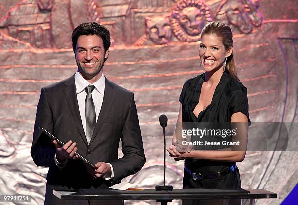 Actors Reid Scott and Tricia Helfer speak on stage at the 24th Genesis Awards at The Beverly Hilton Hotel on March 20, 2010 in Beverly Hills,...