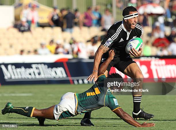 Zar Lawrence of New Zealand is tackled by Branco du Preez of South Africa during day three of the IRB Adelaide International Rugby Sevens match...