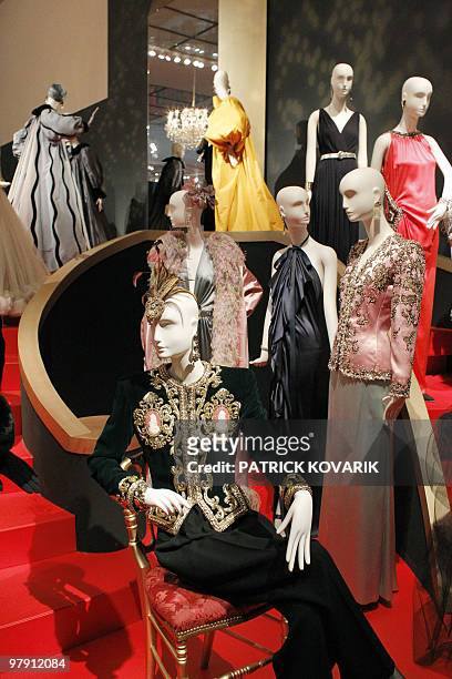 Major retrospective for fashion genius Saint Laurent Models of ball gowns are displayed during an exhibition dedicated to Yves Saint-Laurent on March...