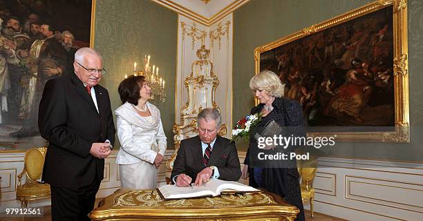 Prince Charles, Prince of Wales signs the visitors book watched by Camilla, Duchess of Cornwall and President of the Czech Republic Vaclav Klaus and...