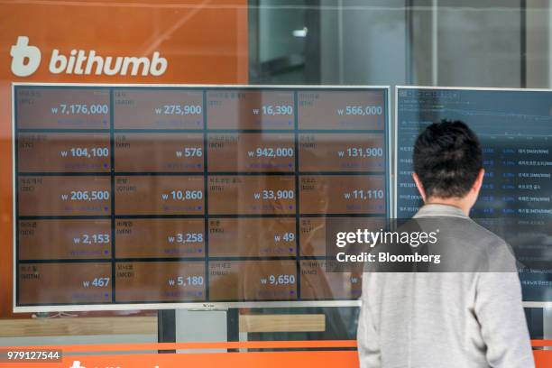 Man looks at monitors displaying the prices of cryptocurrencies at a Bithumb exchange office in Seoul, South Korea, on Wednesday, June 20, 2018....