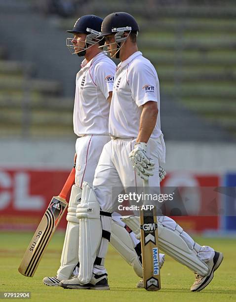 England cricketers Jonathan Trott and Ian Bell leave the field during the second day of the second Test match between Bangladesh and England at the...