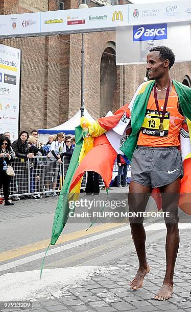 Ethiopian Siraj Gena's stands barefoot after winning the 16th Rome Marathon 'Maratona di Roma' on March 21, 2010.Gena arrived barefoot in memory of...