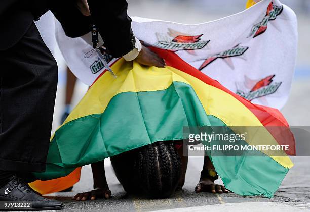 Ethiopian Firehiwot Dado Tufa kisses the ground as she crosses the finish line after winning the 16th Rome Marathon 'Maratona di Roma' on March 21,...