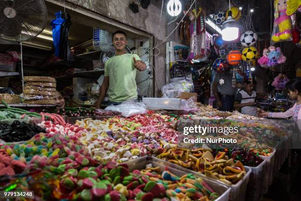 Boy is selling sweets in a shop in the old town of Jerusalem.