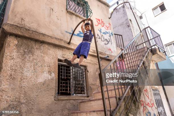 Palestinian children play on a street of Amari refugee camp near Ramallah, Palestine on June 9, 2018. Refugees in Palestine live in poverty.