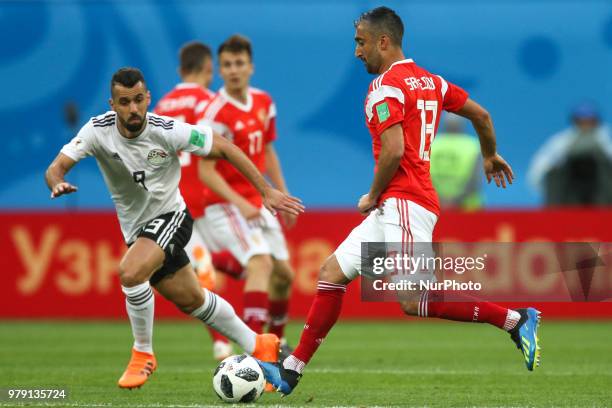 Abdalla Said of the Egypt national football team and Alexander Samedov of the Russia national football team vie for the ball during the 2018 FIFA...