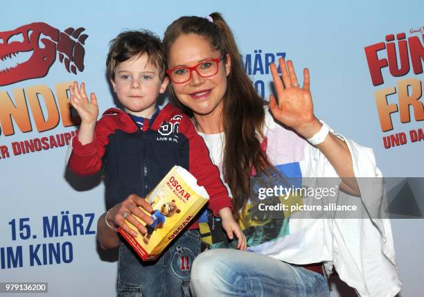 March 2018, Germany, Munich: Actress Doreen Dietel and her son Marlow arriving at the premiere of 'Fünf Freunde und das Tal der Dinosaurier' . The...