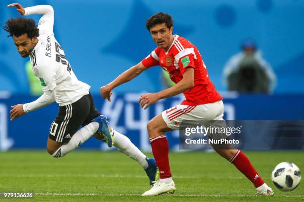 Mohamed Salah of the Egypt national football team and Yury Zhirkov of the Russia national football team vie for the ball during the 2018 FIFA World...