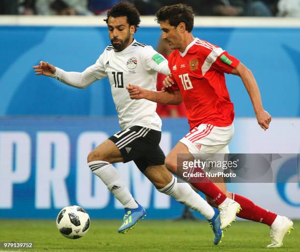 Mohamed Salah of the Egypt national football team and Yury Zhirkov of the Russia national football team vie for the ball during the 2018 FIFA World...