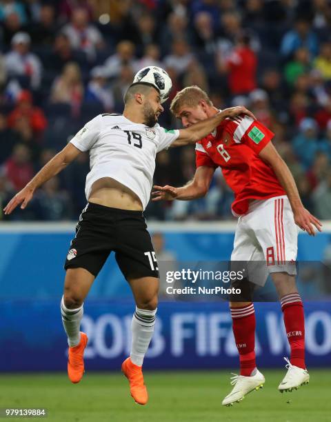 Abdalla Said of the Egypt national football team and Iury Gazinsky of the Russia national football team vie for the ball during the 2018 FIFA World...