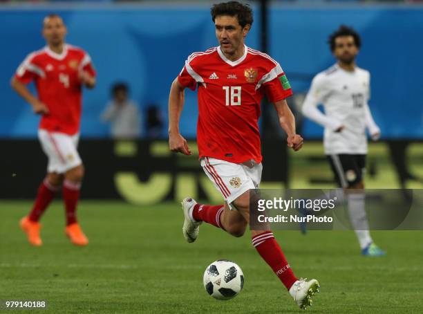 Yury Zhirkov of the Russia national football team vie for the ball during the 2018 FIFA World Cup match, first stage - Group A between Russia and...