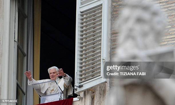 Pope Benedict XVI adrresses the faithful from the window of his apartment during his Sunday Angelus prayer in St. Peter's square at the Vatican on...