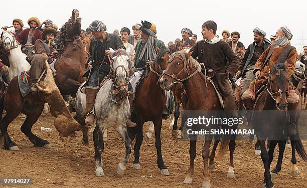 Afghan horsemen play Buzkashi, a traditional sport played on horseback, in the northern city of Mazar-i-Sharif, the capital of the ancient Balkh...