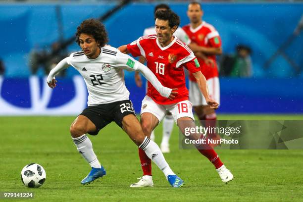 Amr Warda of the Egypt national football team and Yury Zhirkov of the Russia national football team vie for the ball during the 2018 FIFA World Cup...