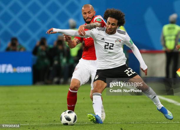 Fedor Kudriashov of the Russia national football team and Amr Warda of the Egypt national football team vie for the ball during the 2018 FIFA World...