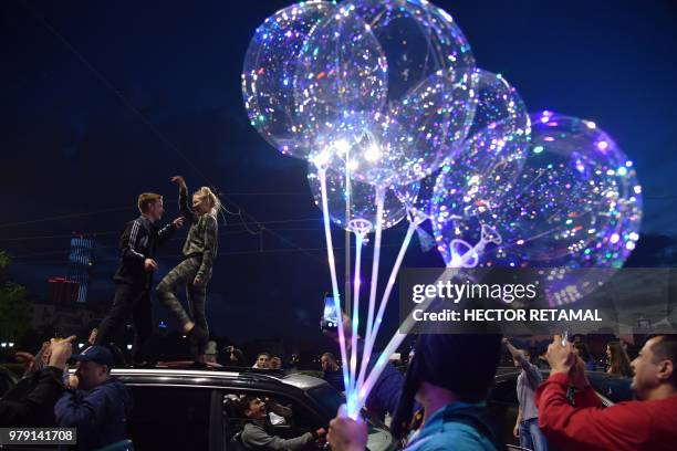 Russia's national football team fans dance on a car as they celebrate their team's victory in the streets of Ekaterinburg, after the Russia 2018...