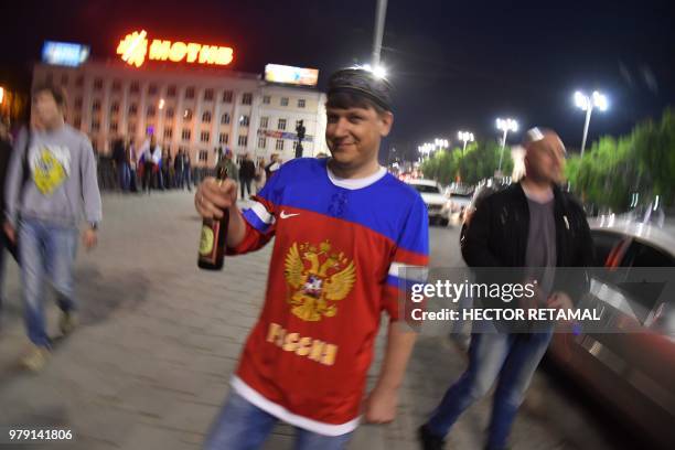 Russia's national football team fan dances as he celebrates his team's victory in the streets of Ekaterinburg, after the Russia 2018 World Cup Group...