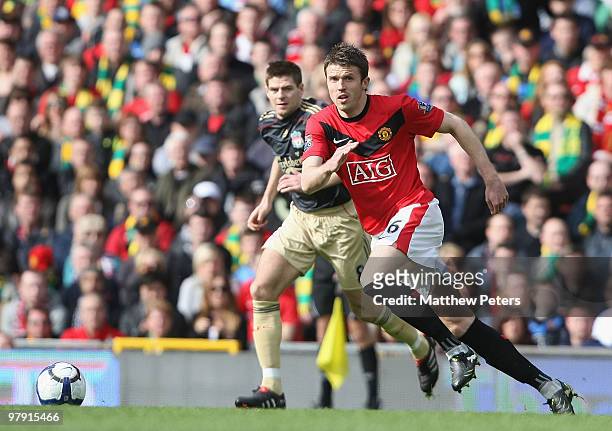 Michael Carrick of Manchester United clashes with Steve Gerrard of Liverpool during the FA Barclays Premier League match between Manchester United...