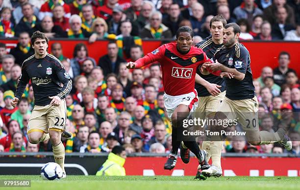 Antonio Valencia of Manchester United clashes with Javier Mascerano of Liverpool and wins a penalty during the FA Barclays Premier League match...