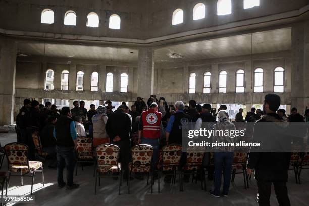 Members of UN agencies, the International Committee for the Red Cross, and the Syrian Arab Red Crescent deliver aid to the people of the rebel-held...