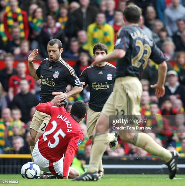 Antonio Valencia of Manchester United clashes with Javier Mascerano of Liverpool and wins a penalty during the FA Barclays Premier League match...