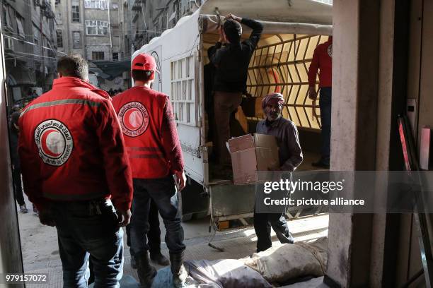 Dpatop - Volunteers unload aid material delivered to the rebel-held city of Douma, Eastern Ghouta province, Syria, 05 March 2018. A 46-truck convoy...