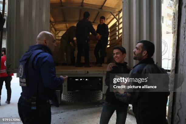 Volunteers unload aid material delivered to the rebel-held city of Douma, Eastern Ghouta province, Syria, 05 March 2018. A 46-truck convoy includes...