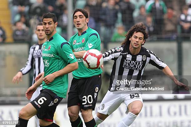 Marcelo Larrondo of AC Siena competes for the ball with Miguel Angel Britos and Francesco Modesto of Bologna FC during the Serie A match between AC...