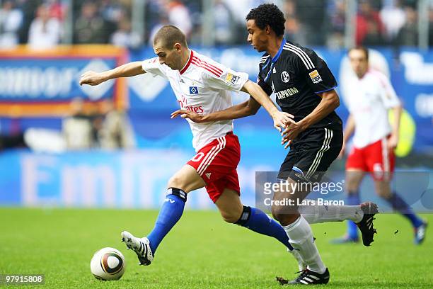 Mladen Petric of Hamburg is challenged by Joel Matip of Schalke during the Bundesliga match between Hamburger SV and FC Schalke 04 at HSH Nordbank...