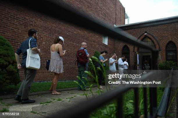 Voters wait in line at the Goodwill Baptist Church before this poling place opens at 7 am in Adams Morgan in Washington, D.C., June 19 to vote during...