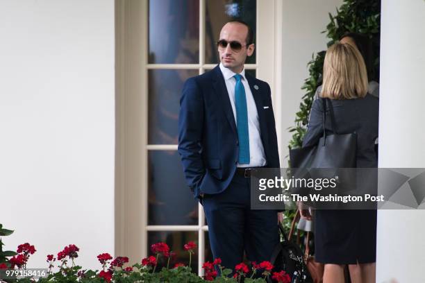 White House senior adviser Stephen Miller watches as President Donald J. Trump walks from the Oval Office to board Marine One on the South Lawn of...