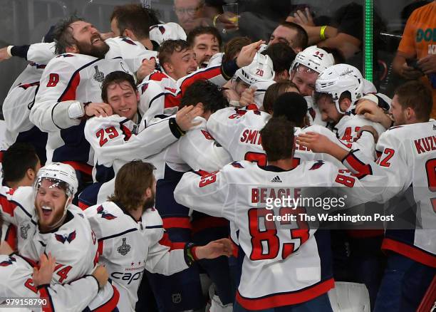 The Washington Capitals mob Washington goaltender Braden Holtby at the end of the game in celebrating winning the Stanley Cup during the second...
