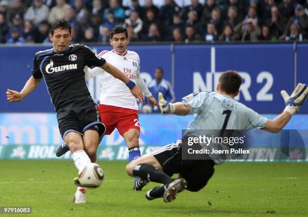 Kevin Kuranyi of Schalke shoots against goalkeeper Frank Rost and Tomas Rincon of Hamburg during the Bundesliga match between Hamburger SV and FC...