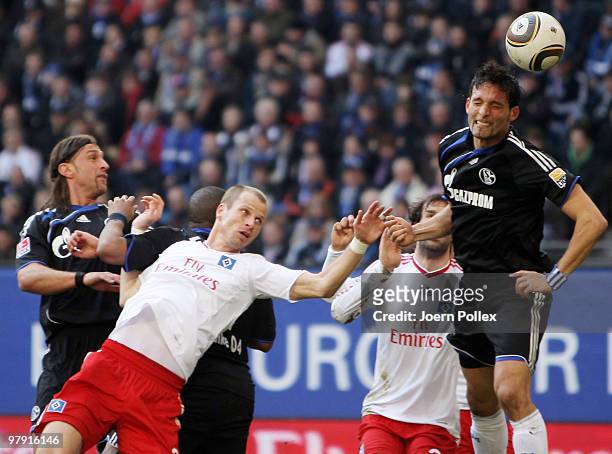 Ruud van Nistelrooy , David Rozehnal of Hamburg and Kevin Kuranyi, Jefferson Farfan as well as Marcelo Bordon of Schalke compete for the ball during...