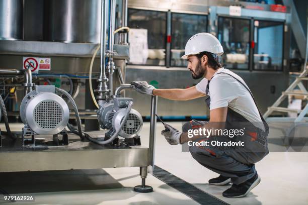 young worker controls the machine - night shift - shift worker stock pictures, royalty-free photos & images