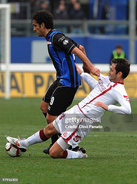 Nicola Amoruso of Atalanta competes with Dario Knezevic of Livorno during the Serie A match between Atalanta BC and AS Livorno Calcio at Stadio...